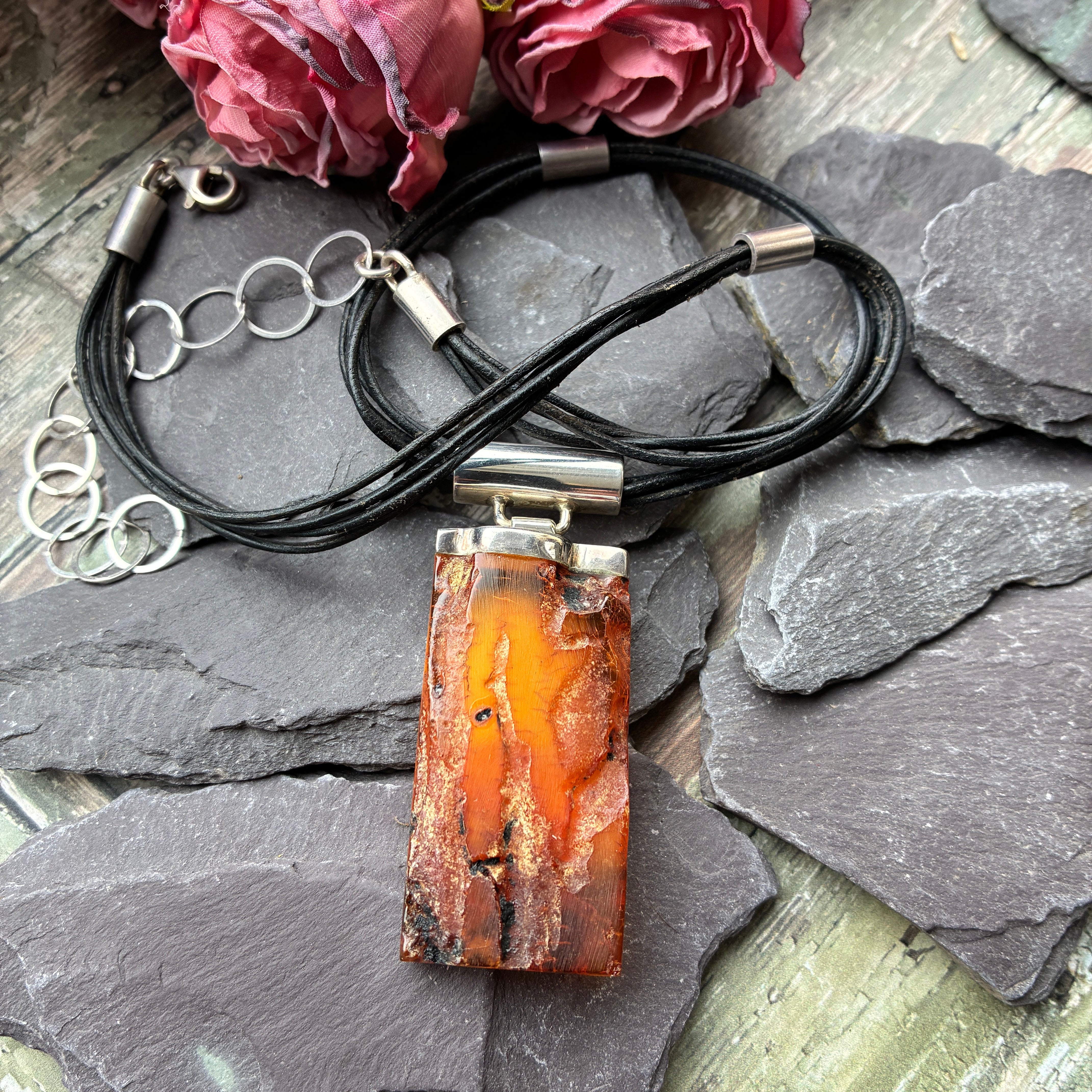 Polish Sterling silver and amber necklace suspended from a silver and leather thong.