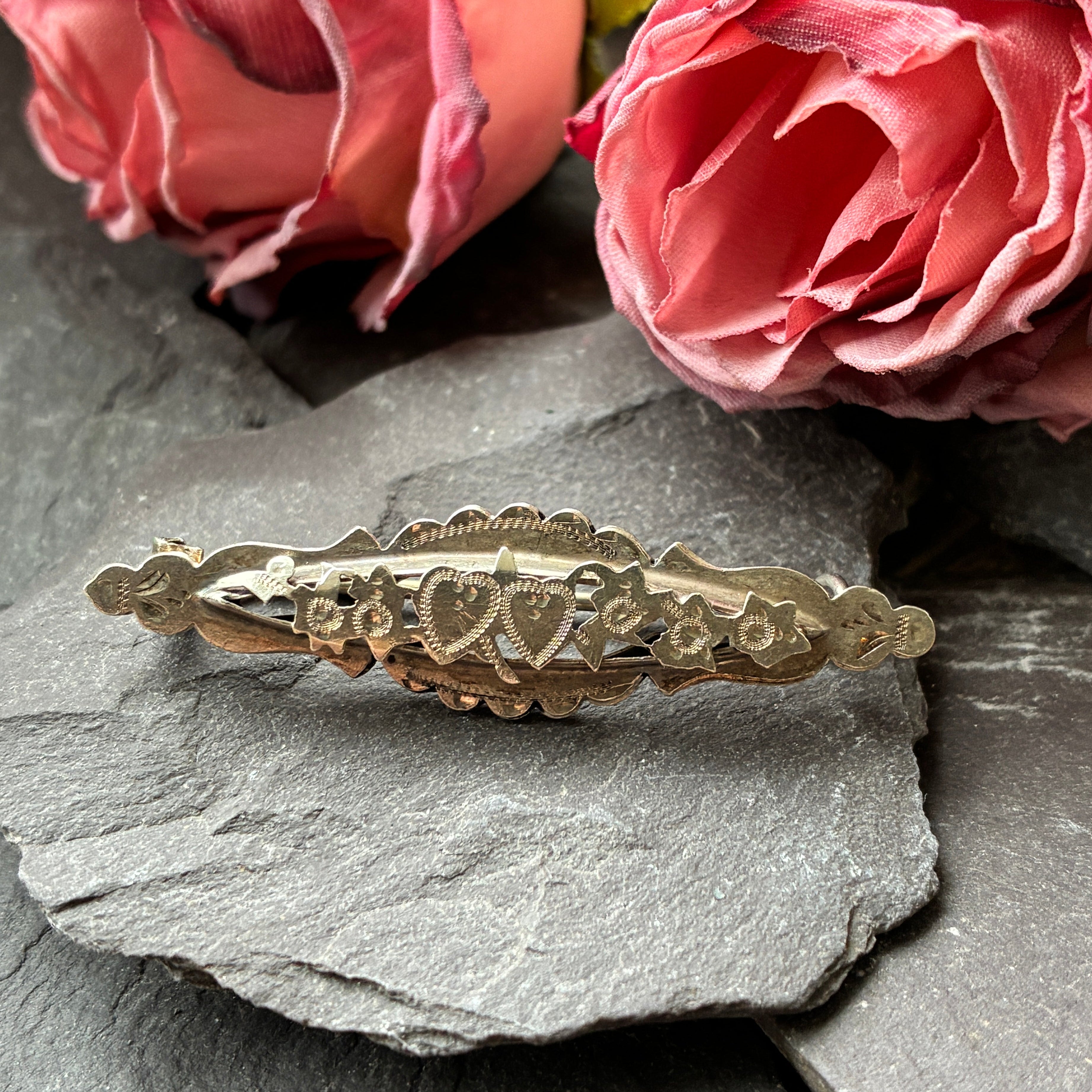 Antique Sterling Silver Sentiment Brooch with hearts and flowers.