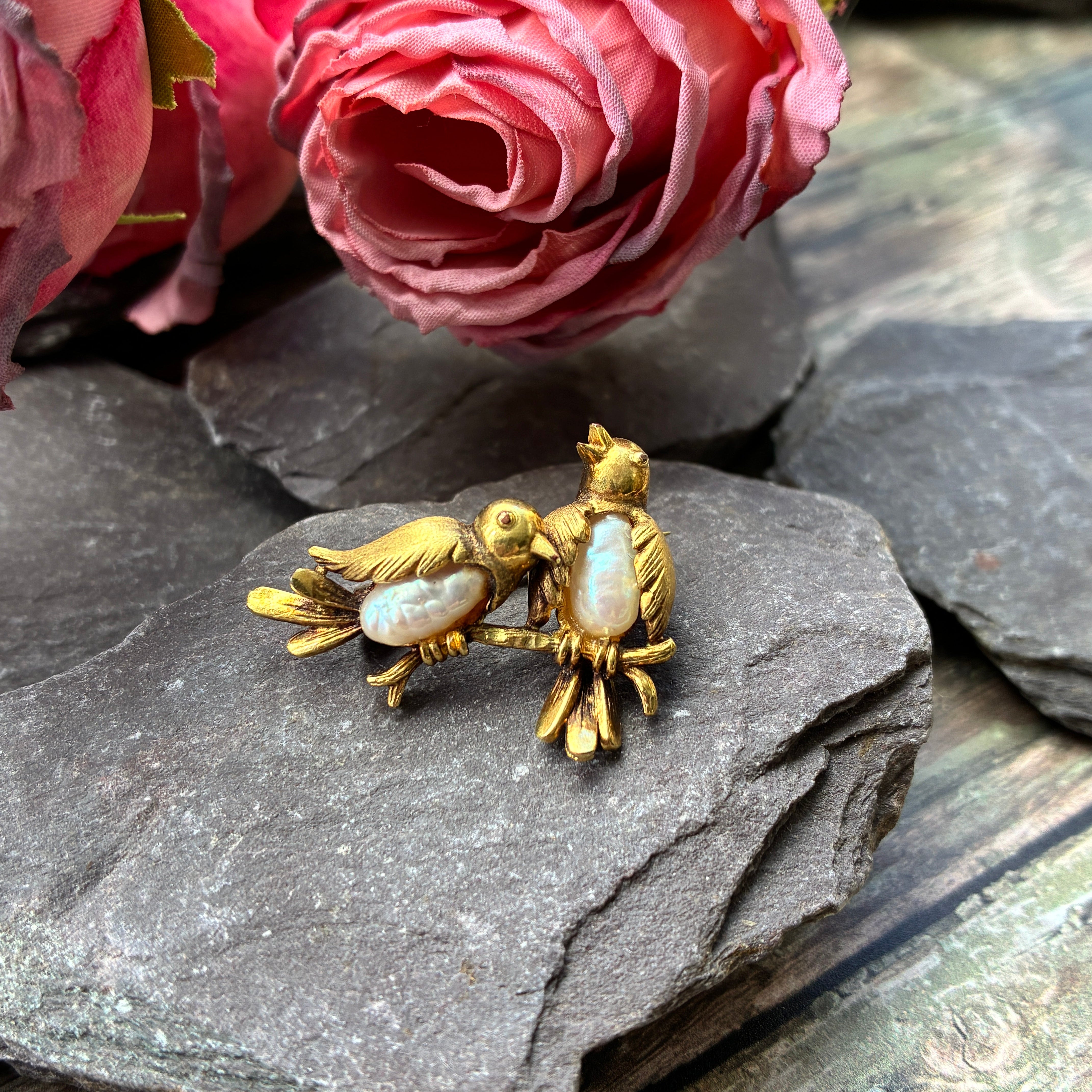 Vintage gold plated freshwater pearl brooch with two birds on a branch.