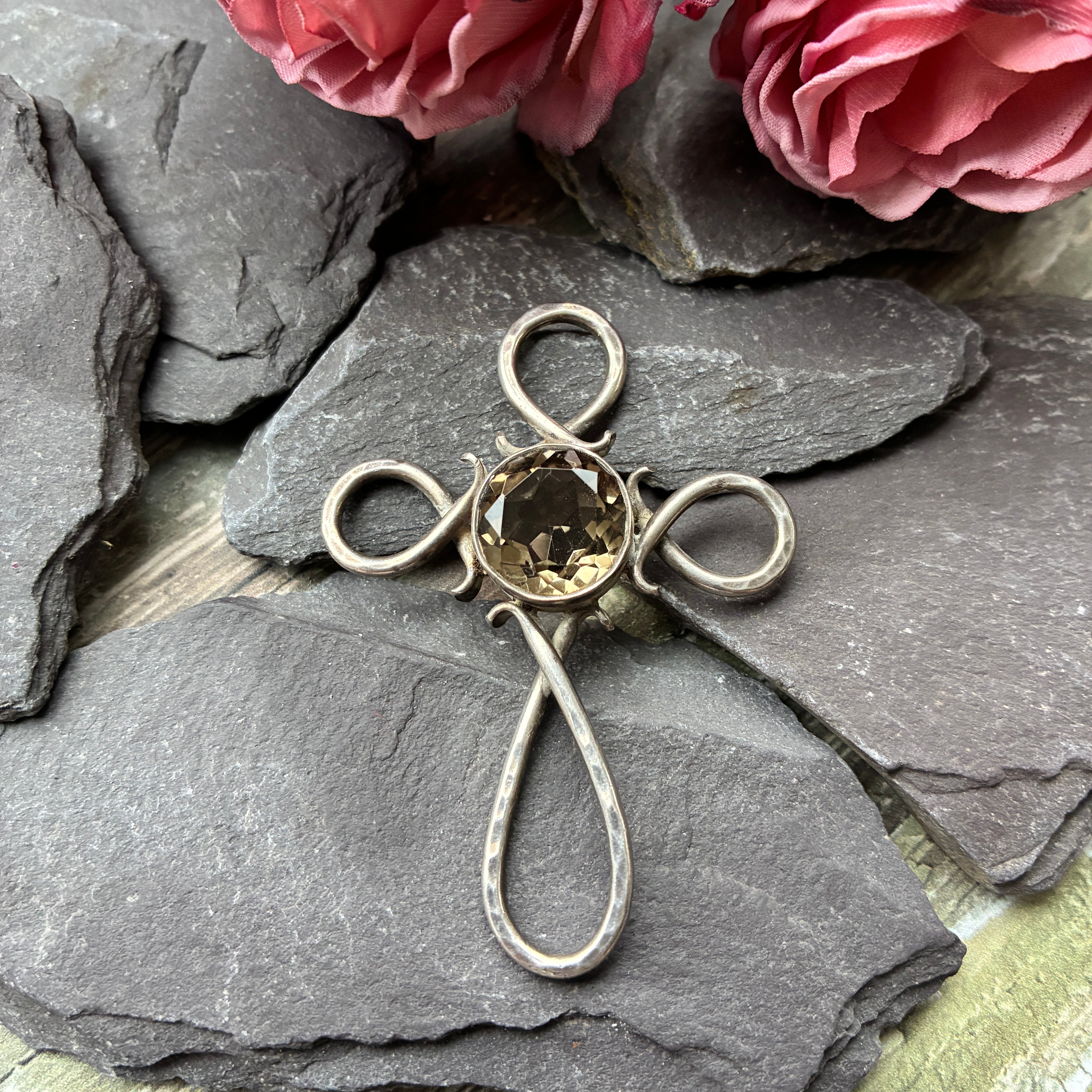 A beautiful sterling silver cross pendant designed and made by David William Harkison.
Set with a natural Citrine