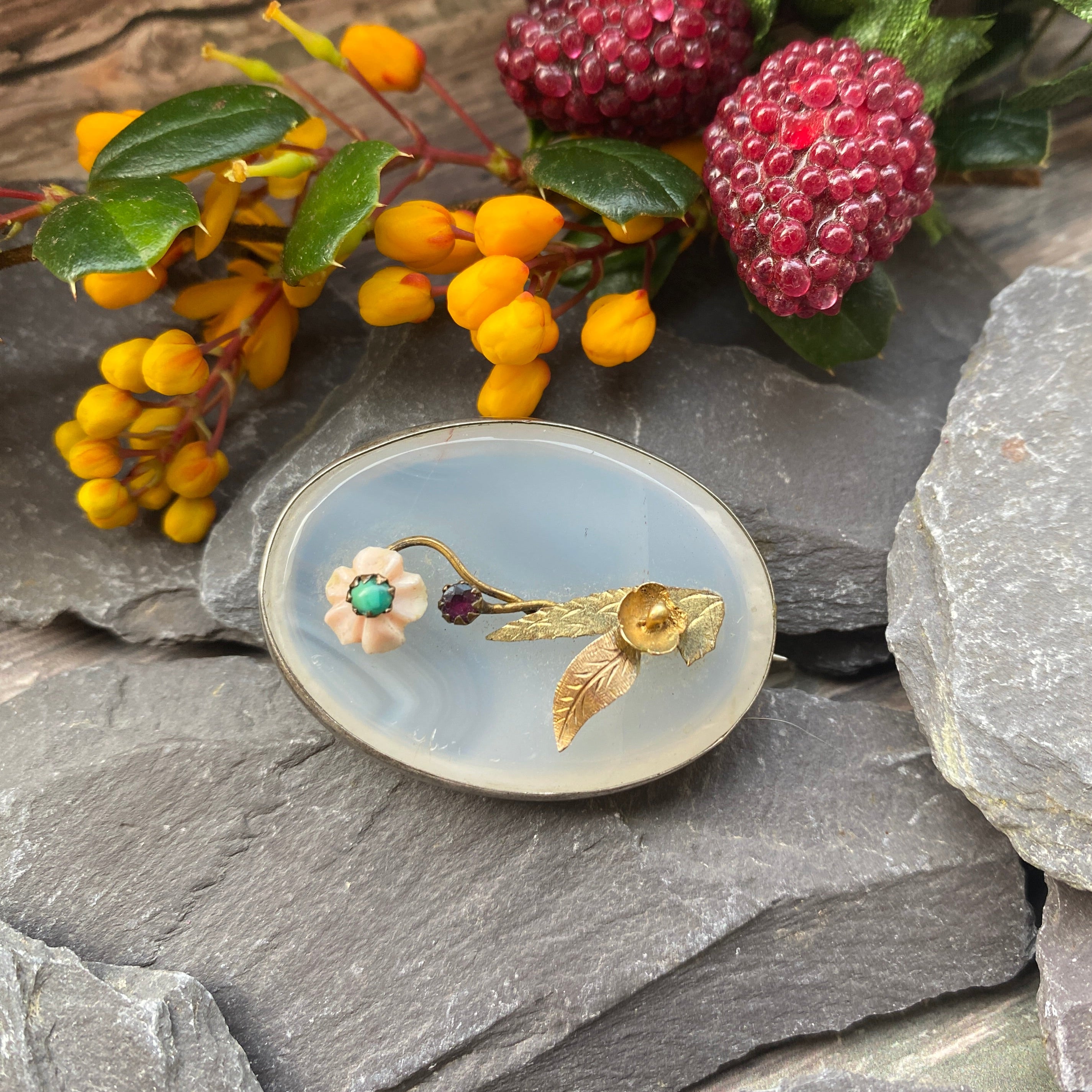 Victorian brooch set with a gold coral and turquoise flower on chalcedony