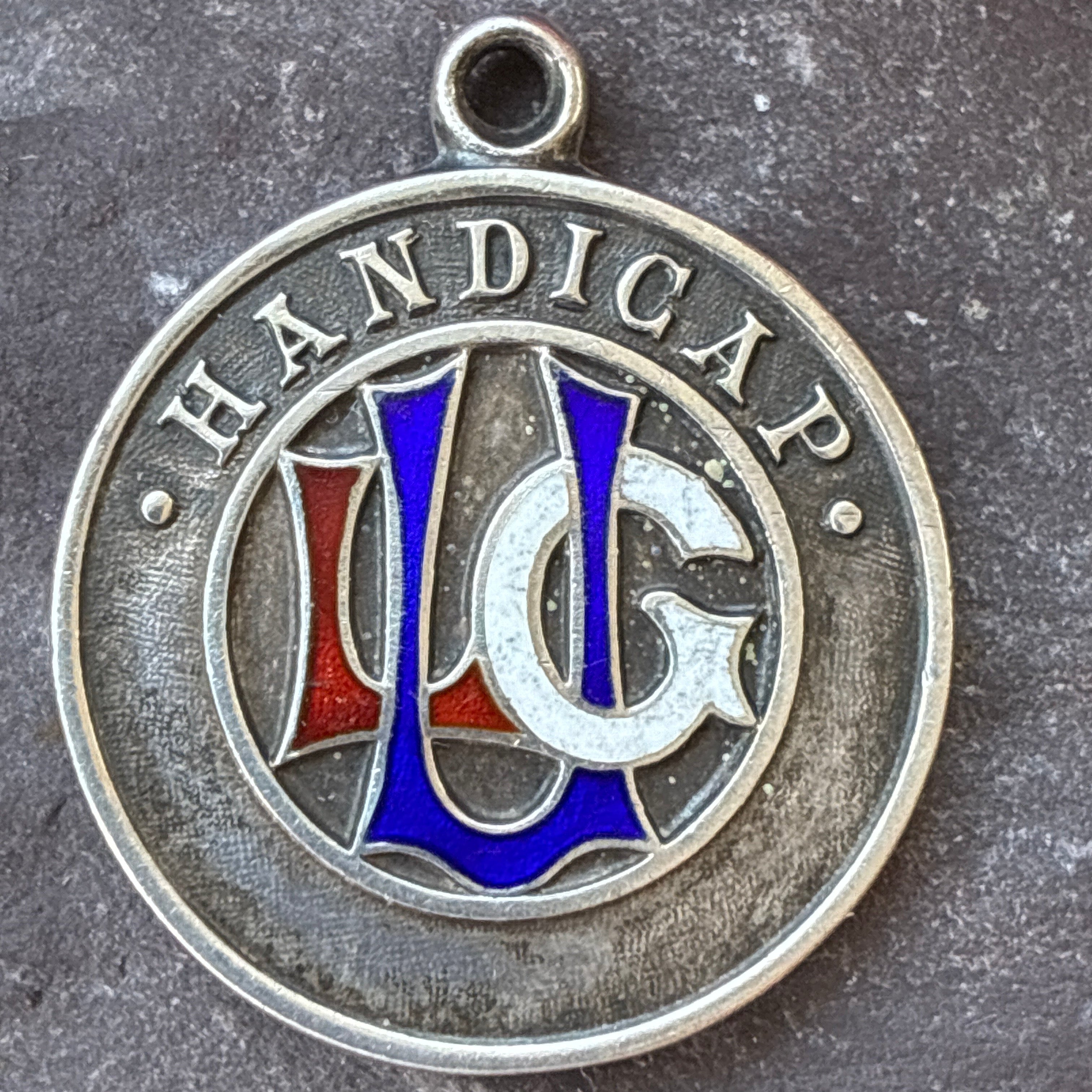 Sterling silver ladies golf union handicap fob medal with red, white and blue enamel.
