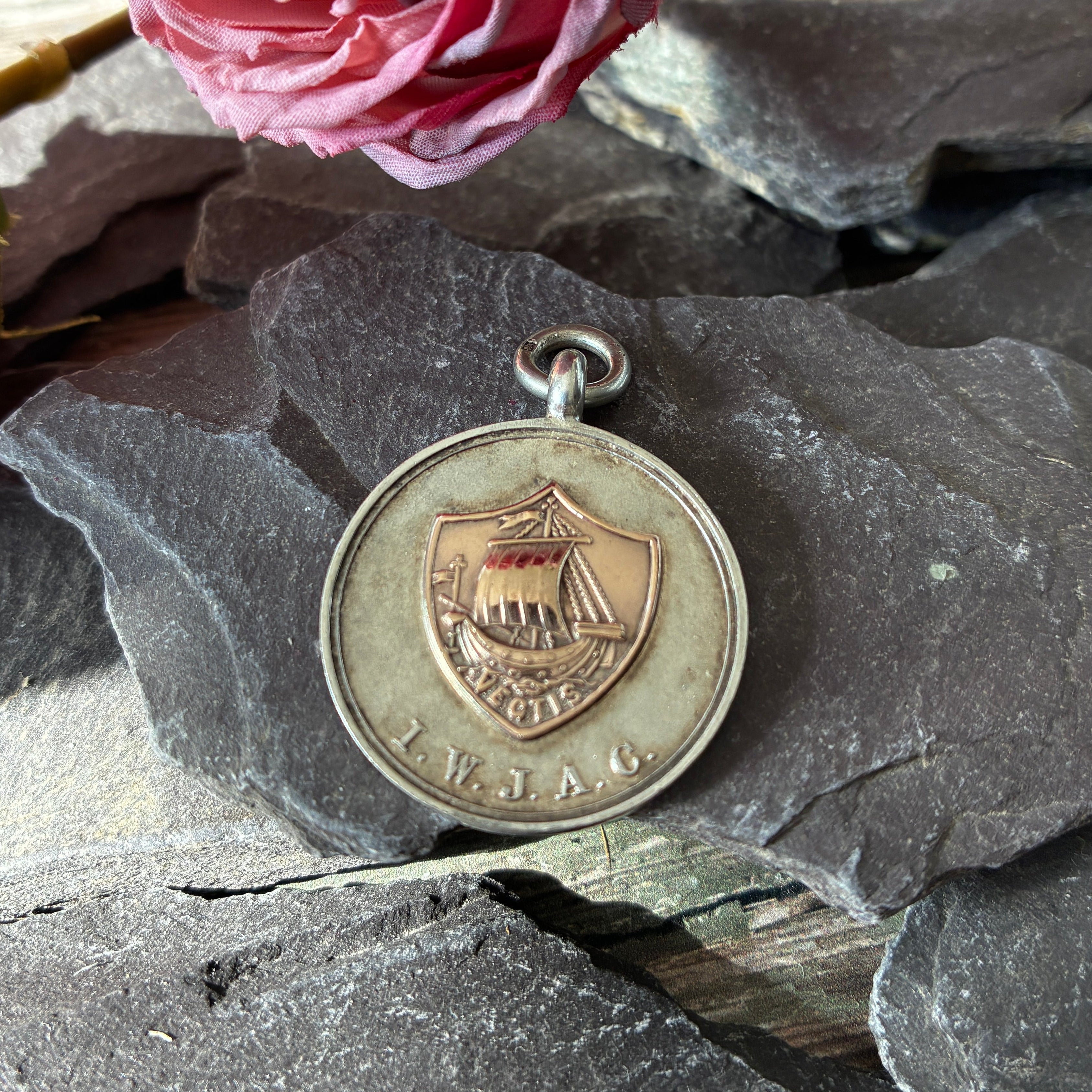 A sterling silver and gold Albert fob medal for Isle Of Wight Junior Athletic Club.