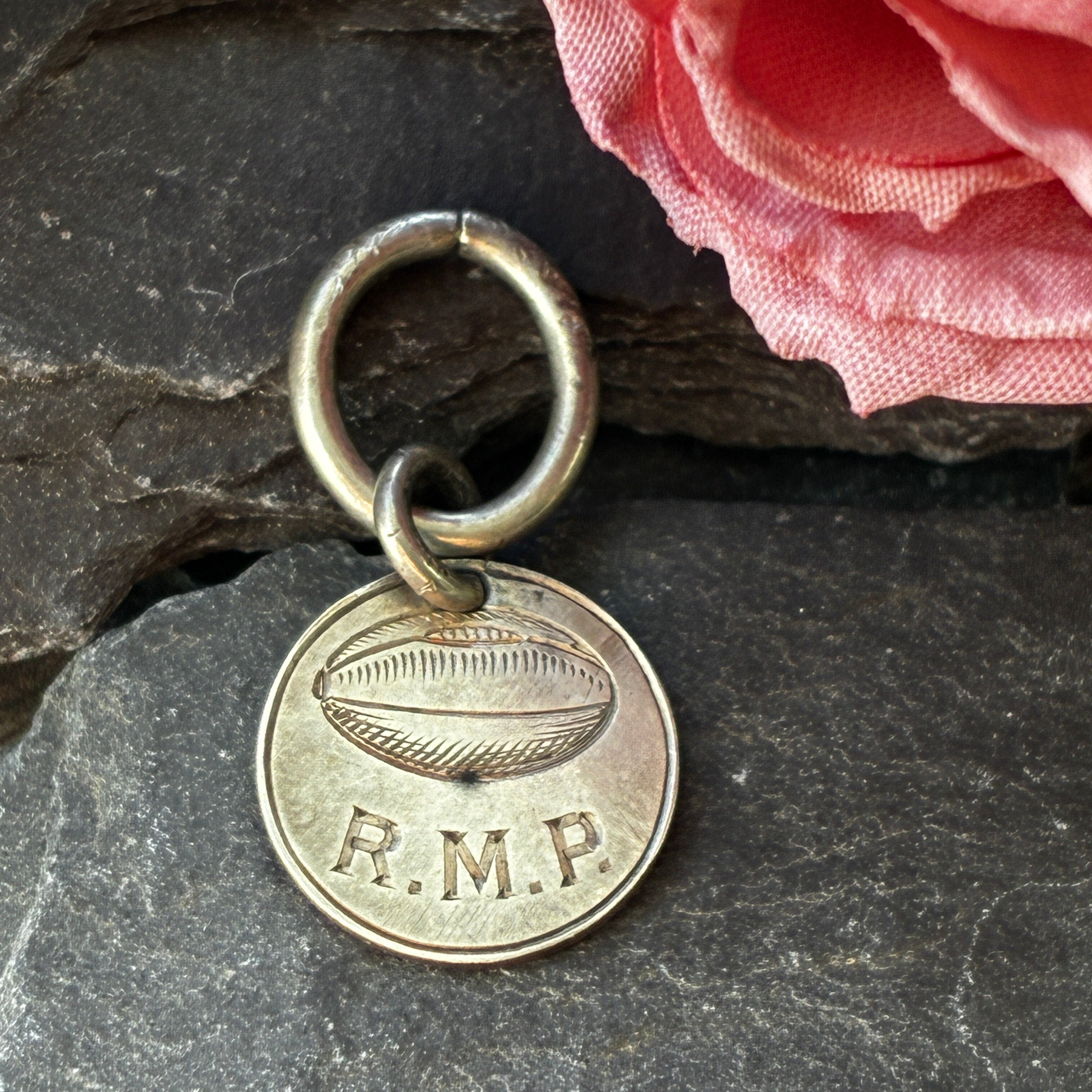Victorian Coin loke token-R.M.P with rugby ball engraved.