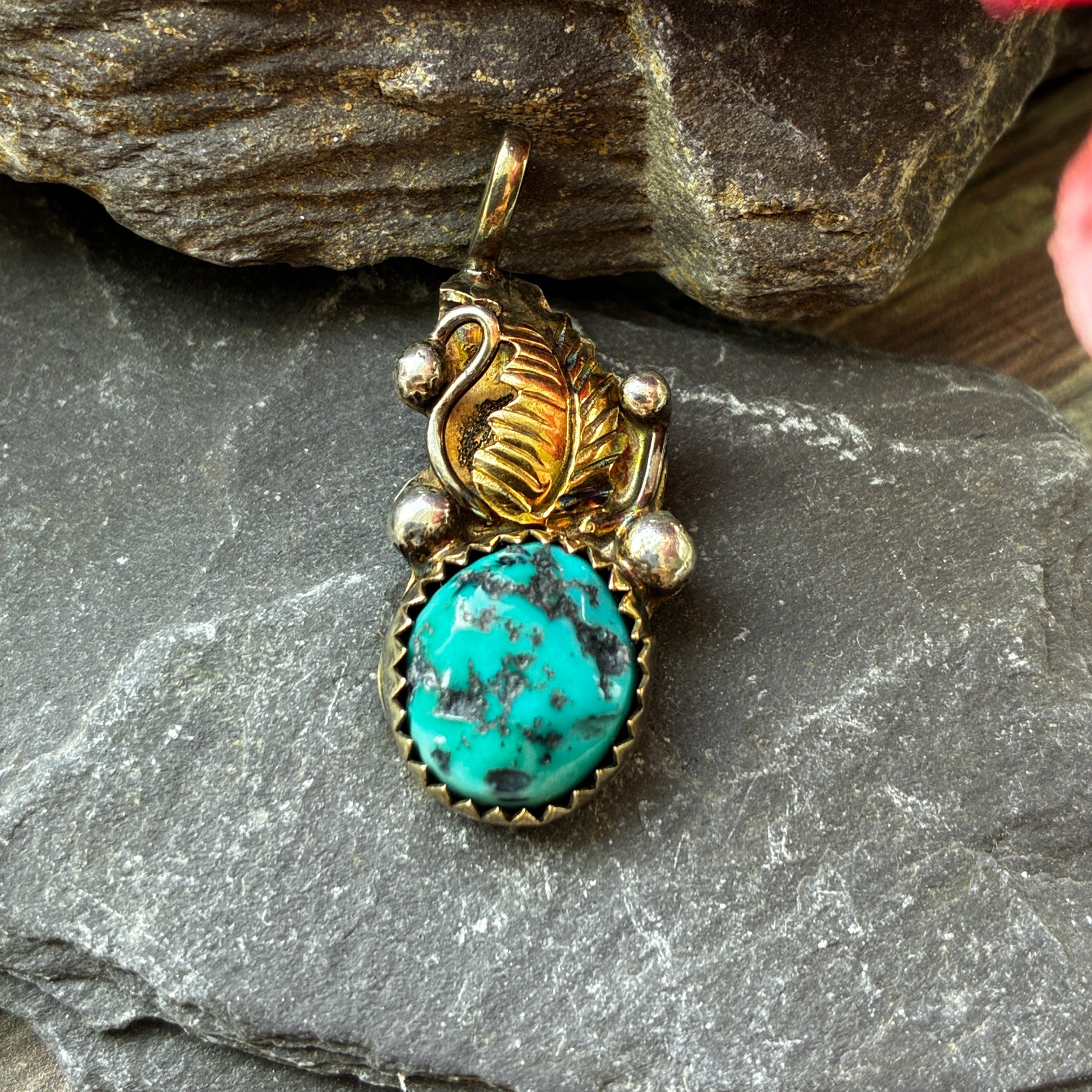 vintage sterling silver and gold signed Navajo pendant.